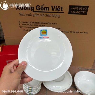 Chiếc đĩa tròn men trắng phẳng mịn in logo thương hiệu nổi bật ở viền đĩa