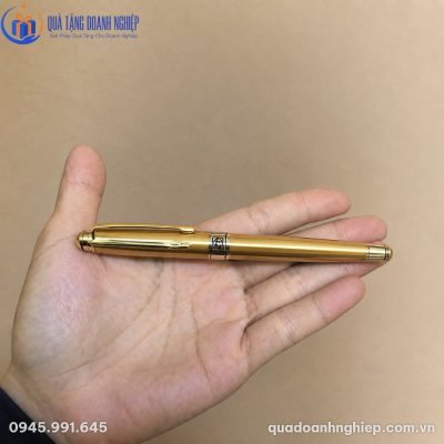 Cận cảnh thân bút ký BK-08 thon gọn màu vàng kim nằm vừa vặn trong lòng bàn tay