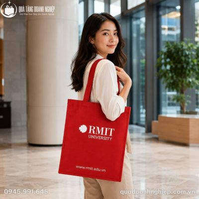 Nữ nhân viên công sở diện trang phục thanh lịch đeo túi vải canvas đỏ RMIT năng động